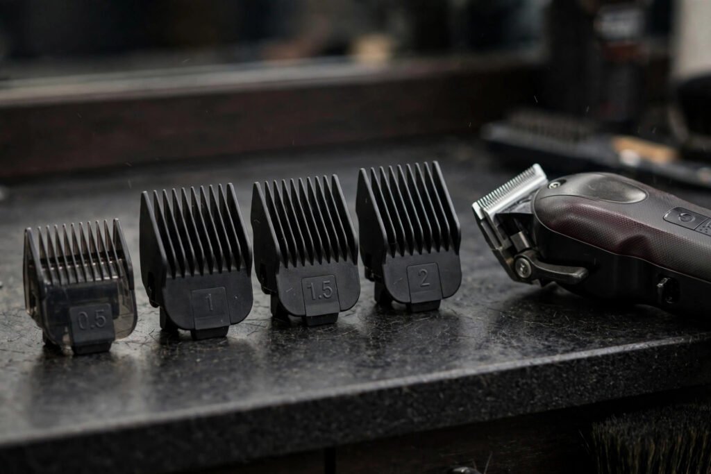 Set of clipper guard attachments numbered 0.5 to 2 on a barbershop counter, close-up