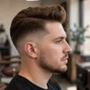 Man with a lifted quiff and clean low taper fade.